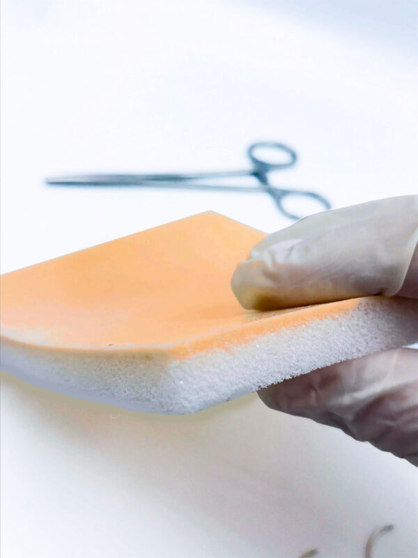 Two-layer skin for suturing